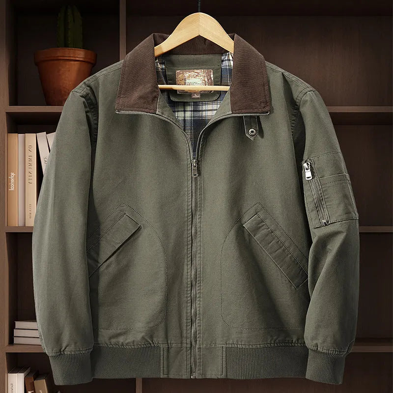 Men's washed cotton baseball flight jacket in beige, shown on a hanger.