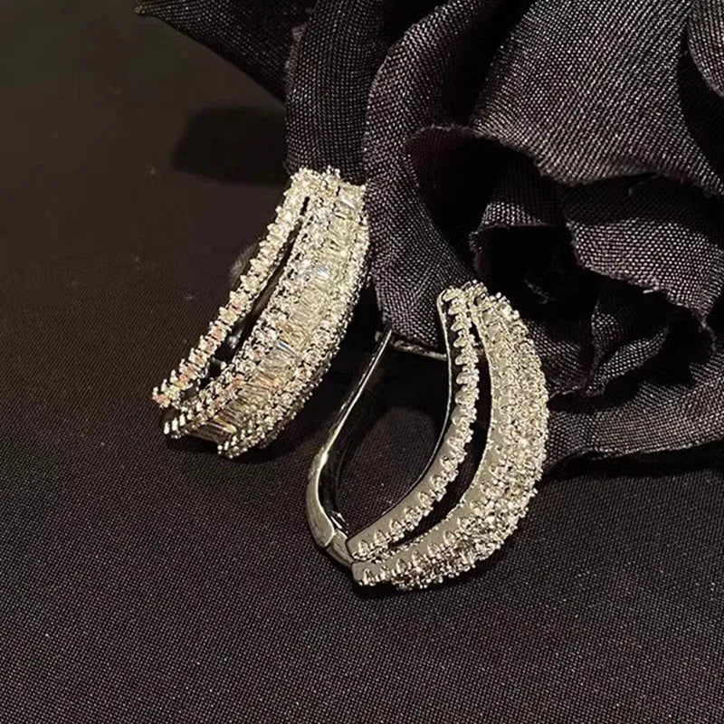 Geometric white gold colour stud earrings with zircon detailing on copper