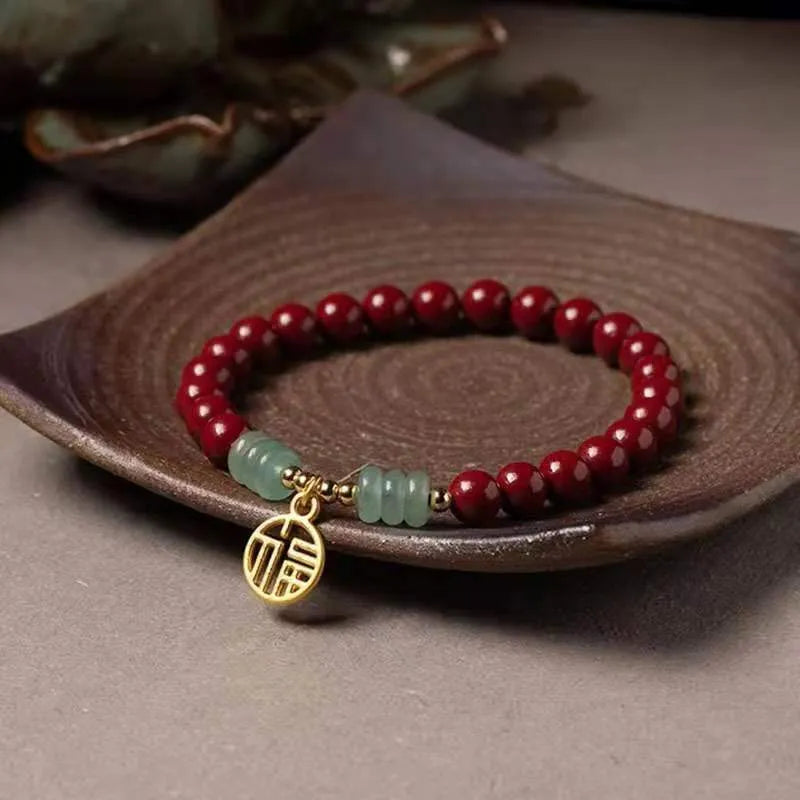 Gold cinnabar and copper bead bracelet in a wave shape on a wrist.