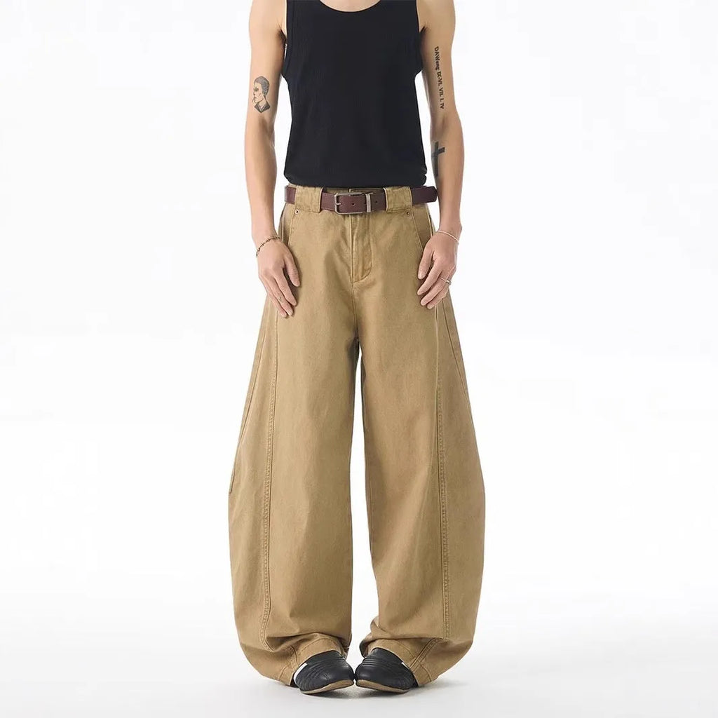 Brown men's loose-fit straight-leg jeans with a button fly on a mannequin.