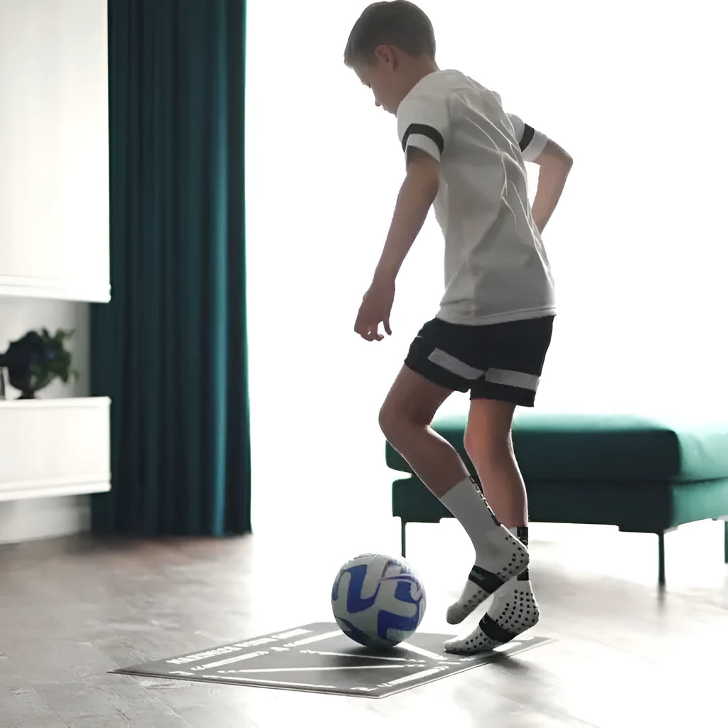 Black rectangular football training mat measuring 60 by 90 centimetres