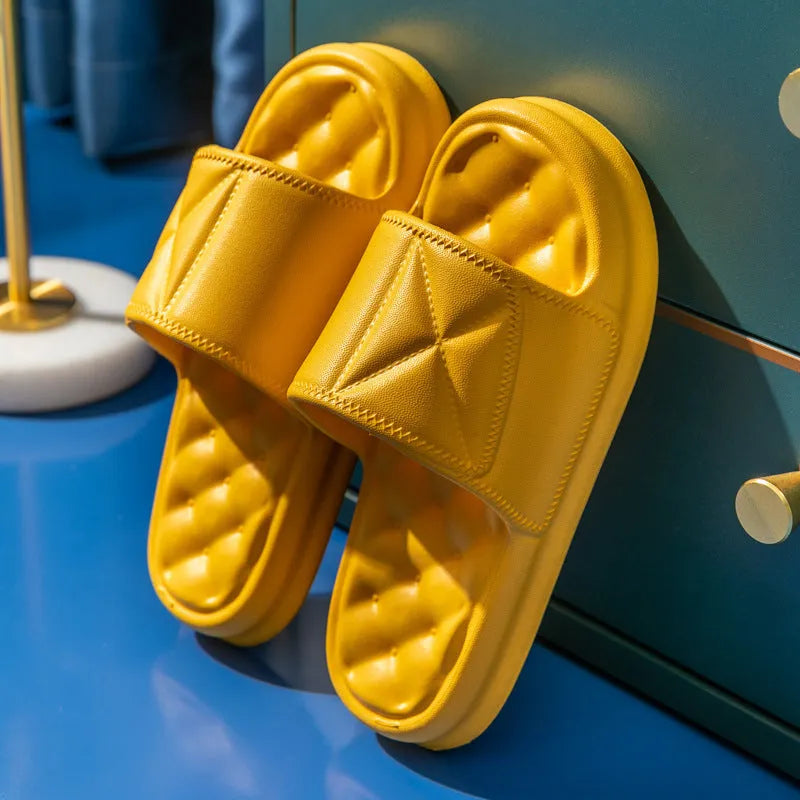 Soft EVA non-slip bathroom slippers with thick sole in assorted colours on a bathroom floor.