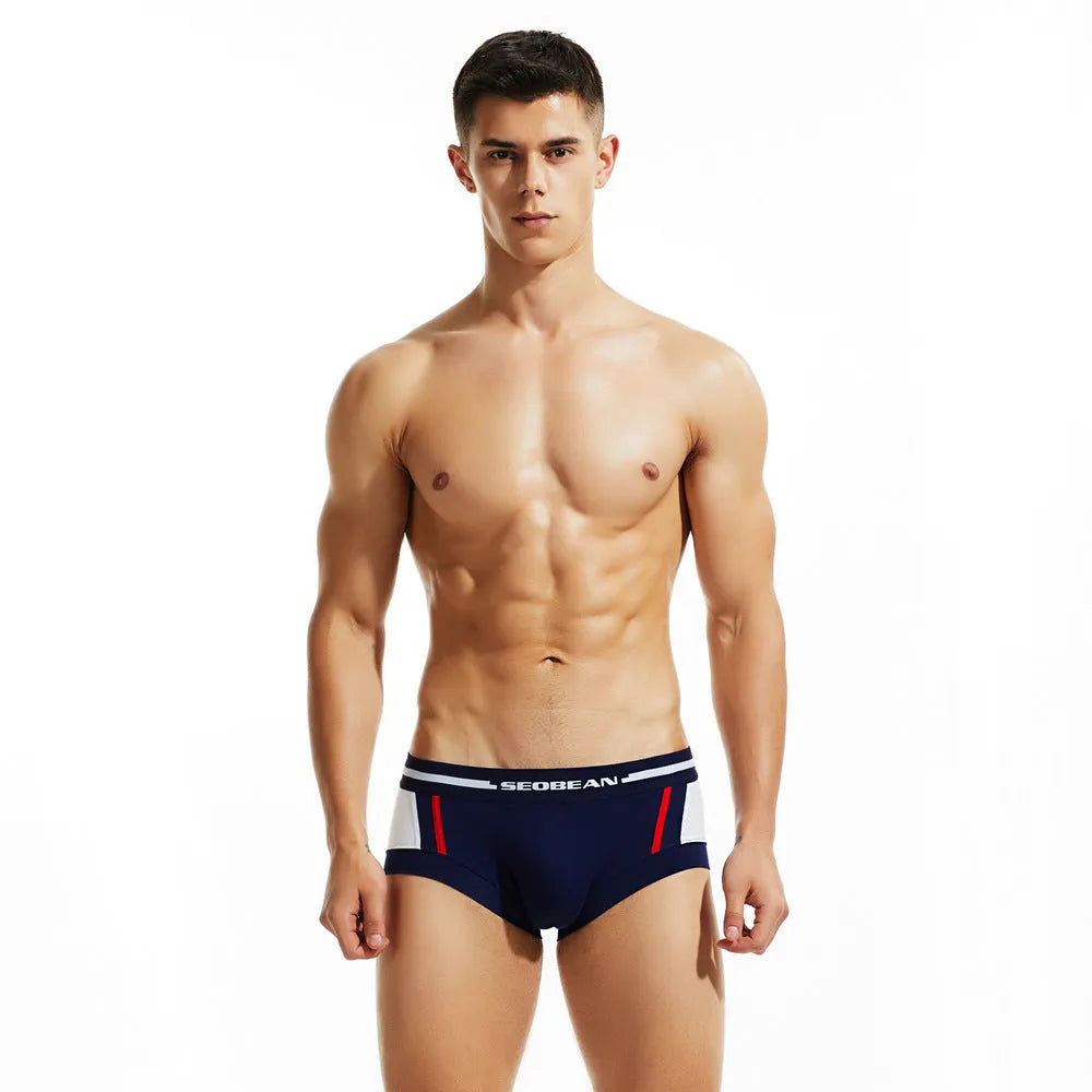 Men's low waist cotton boxer shorts in red, dark blue, or light grey, showing the hip-lifting design.