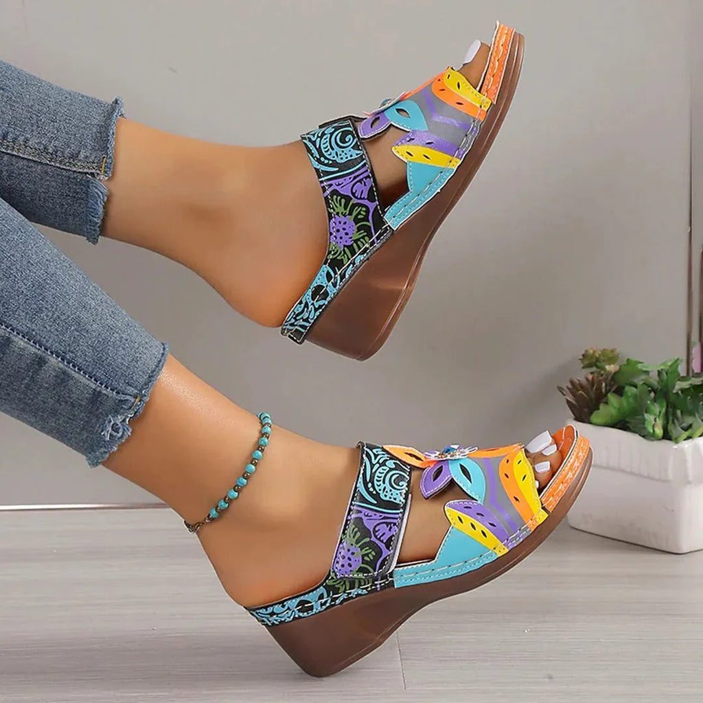 Women's ethnic totem pattern slippers with wedge heel on a solid rubber sole, shown in purple cowhide.
