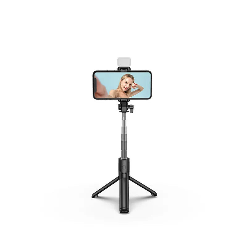 Black aluminium alloy Bluetooth selfie stick with extended tripod legs and a phone attached to the 360-degree rotating holder.