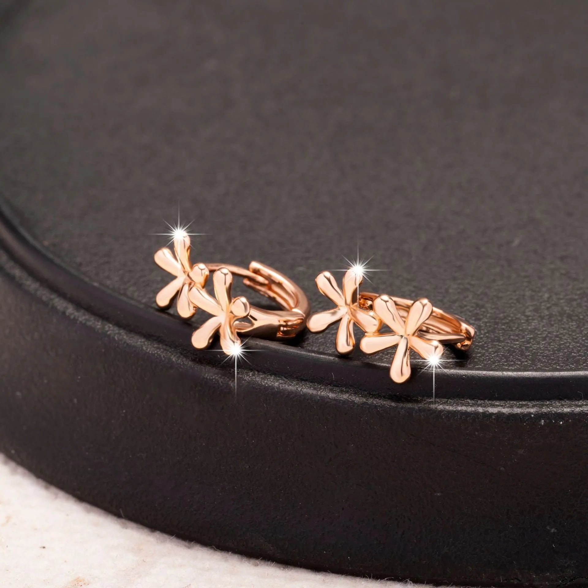 Circular rose gold earrings with waterdrop flower design for women