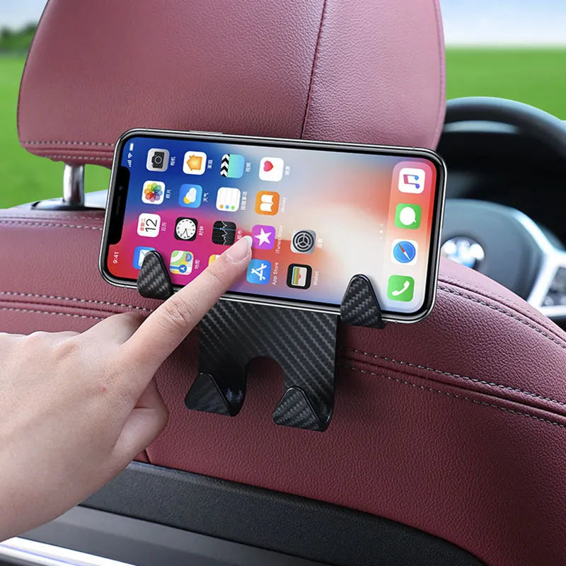 Black ABS plastic car hook and phone holder bracket mounted behind a car seat headrest.