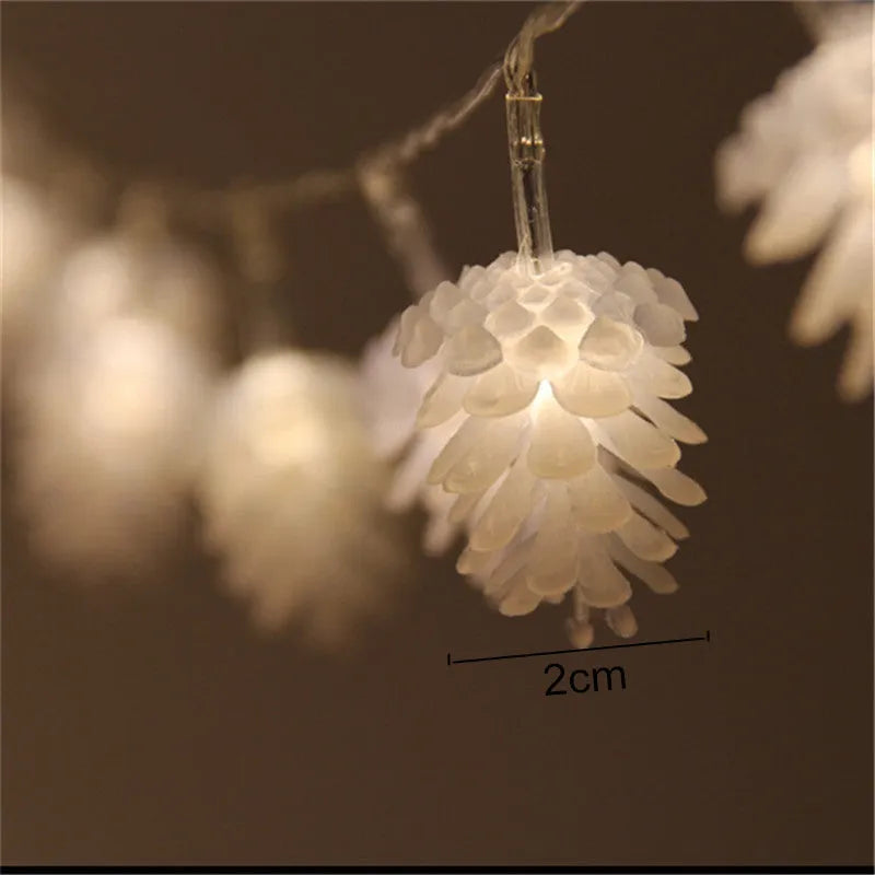 Warm white LED pine cone fairy lights on a string, powered by batteries for cord-free decoration.