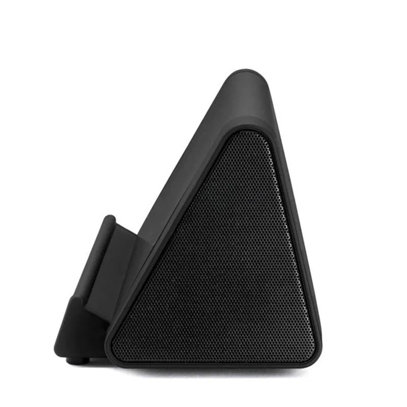 Compact black and white wireless Bluetooth mini speaker with control buttons.