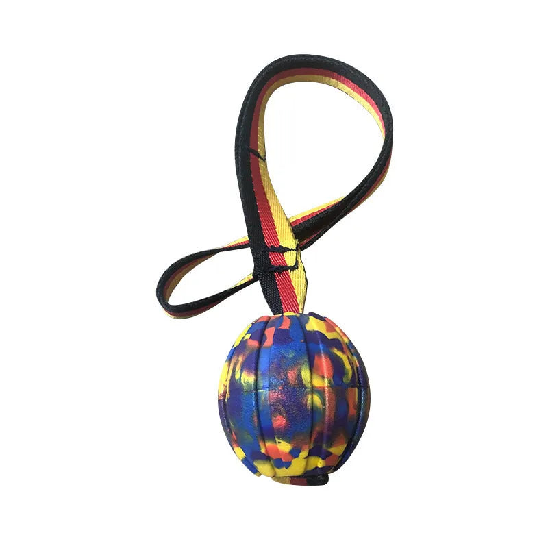 Camouflage and yellow floating EVA dog balls with tether strings in three different sizes on blue background.