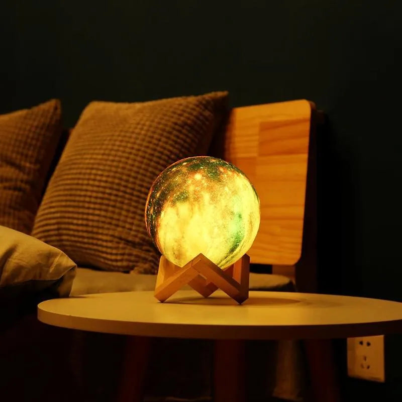 3D printed spherical moon night light with textured surface, shown with remote control.