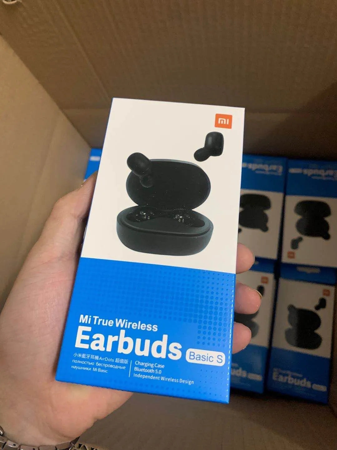 Redmi AirDots Black true wireless earbuds and their white charging case on a table