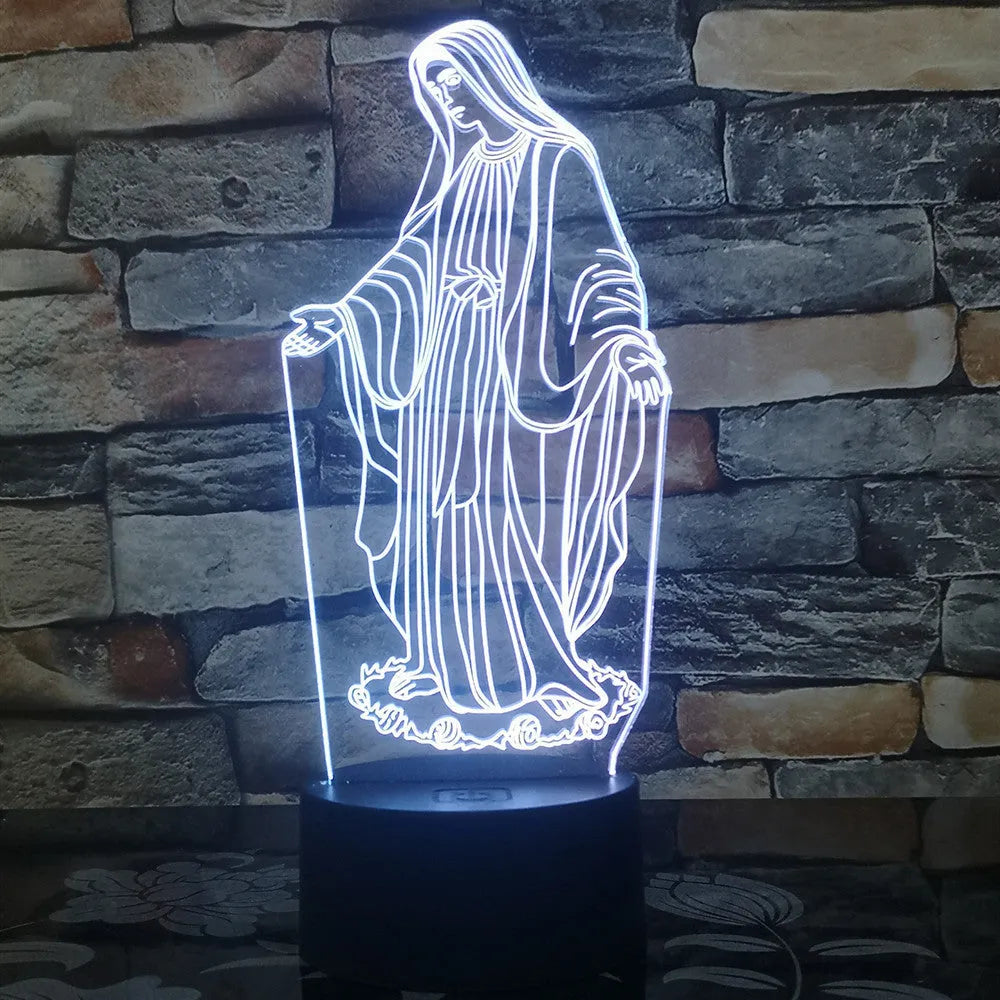 3D LED night light with colourful dual-ring pattern, remote control, and USB cable on a desk.