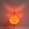 Plastic pumpkin-shaped USB lamp emitting purple or yellow light, 8.3cm wide.