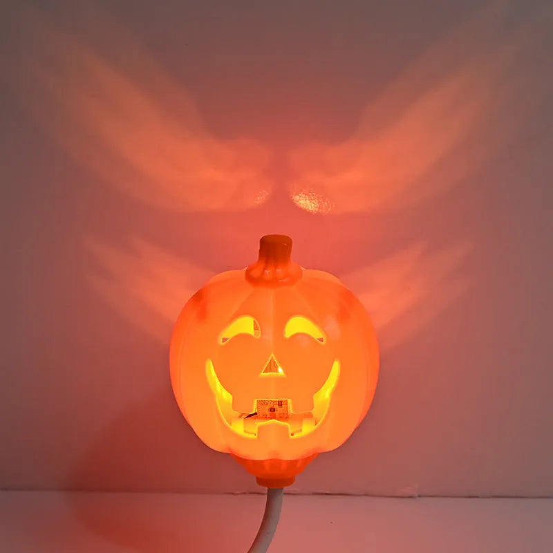 Plastic pumpkin-shaped USB lamp emitting purple or yellow light, 8.3cm wide.