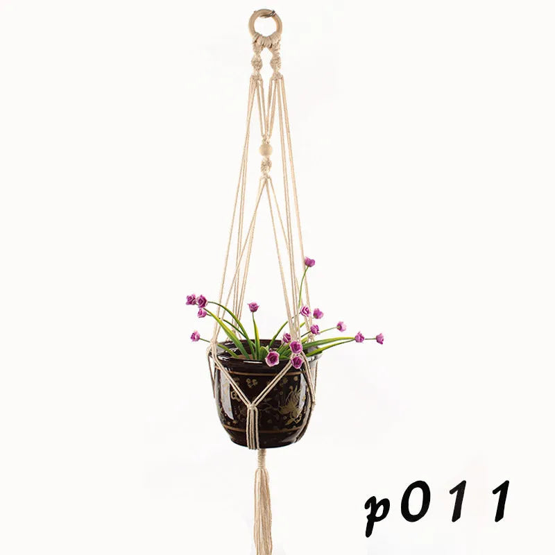 Woven cotton rope plant holder in a desktop style with greenery inside.