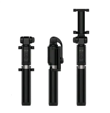 Black Bluetooth selfie stick tripod with remote control extended next to mobile phone