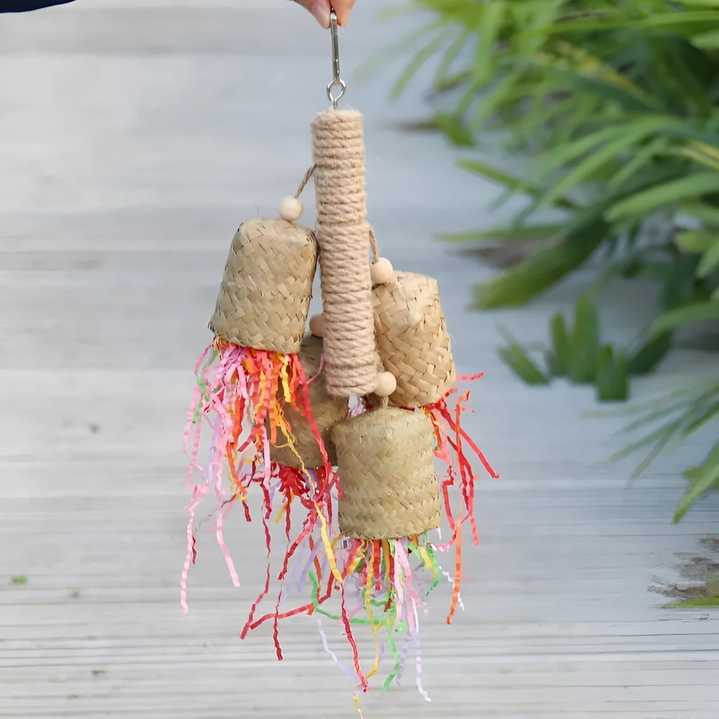 Colourful shredded paper parrot toy made of wood and sisal rope, measuring 35cm long.