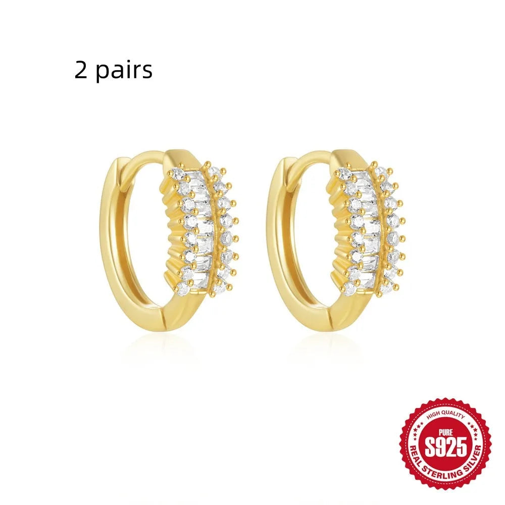 Sterling silver geometric stud earrings with small round diamond detailing in gold and silver electroplated finishes