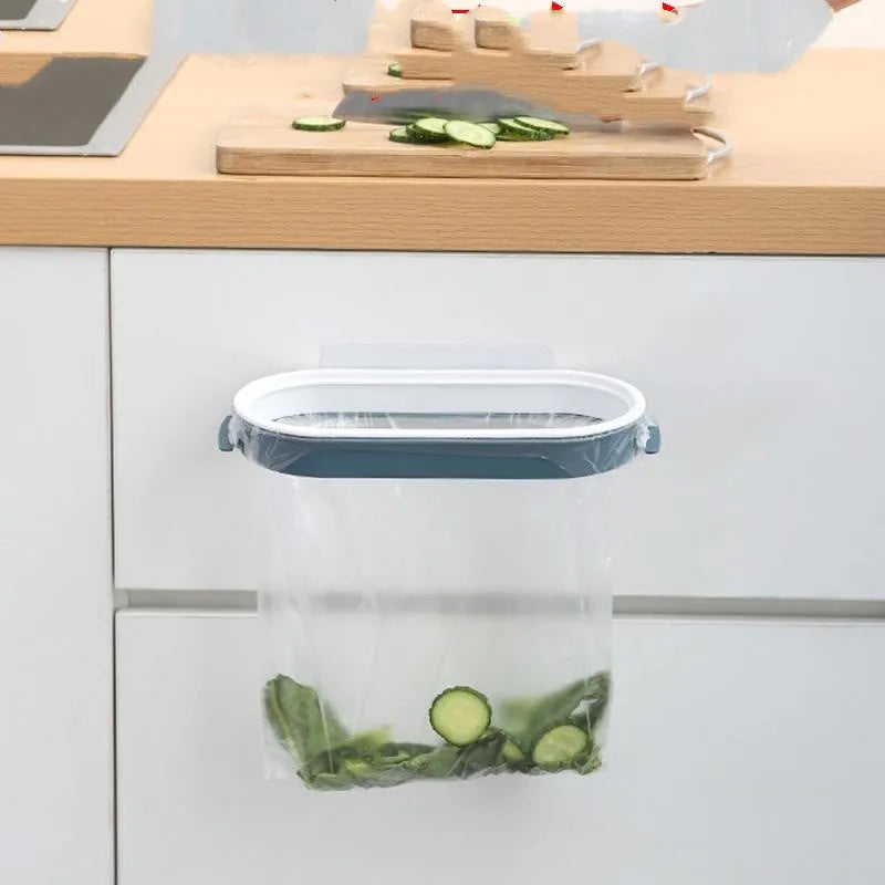Blue plastic kitchen bin bag storage rack mounted on a cabinet door holding a roll of bags.