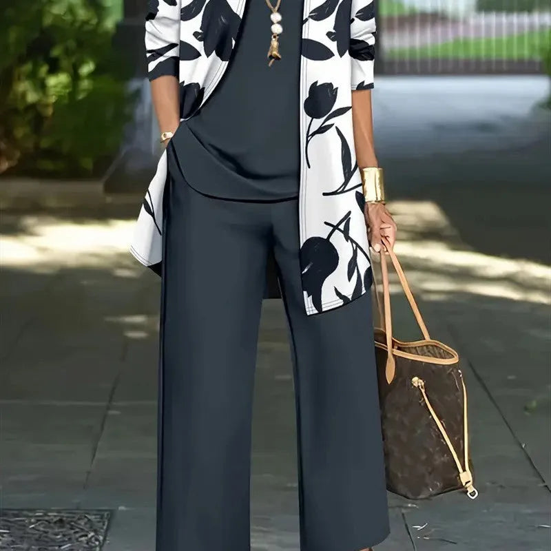 Women's blue three-piece casual suit featuring a long-sleeve coat, a vest, and full-length trousers.