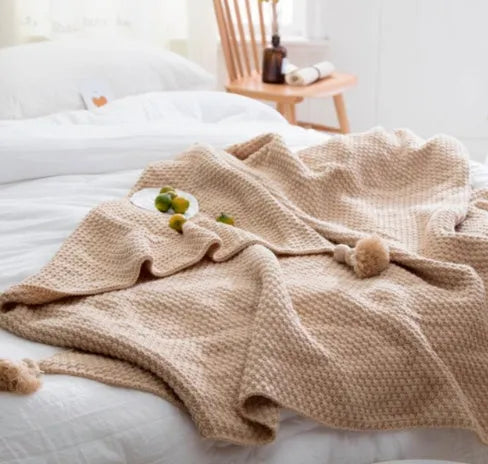 Nordic fringed knit ball acrylic blanket in beige colour, laid flat showing 130x170cm size and fringe detail