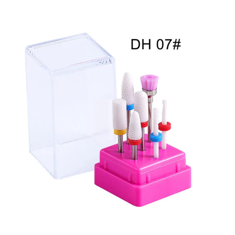 Set of seven tungsten steel nail drill bits and a brush in a transparent storage case.