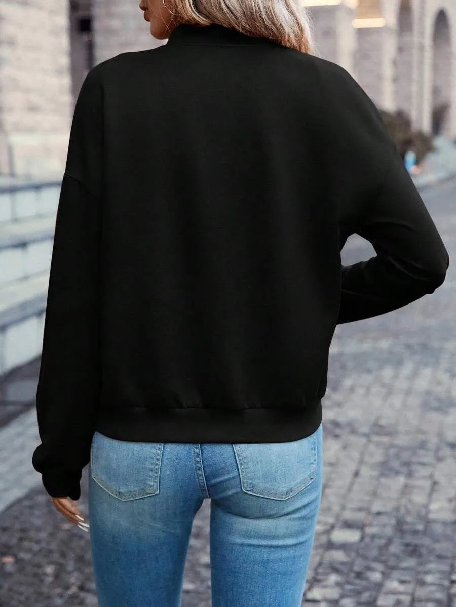 Black women's zip jacket with faux pockets and long sleeves on hanger