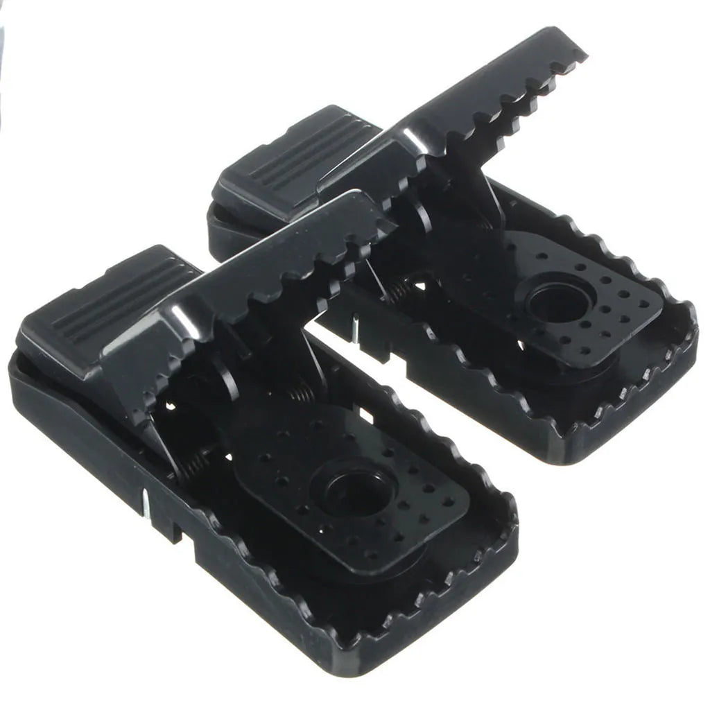 Six black plastic snap-action mousetraps showing their size and smooth surface.