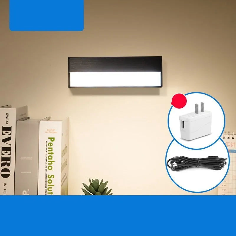 Compact white magnetic table lamp with a large luminous surface and USB charging port.