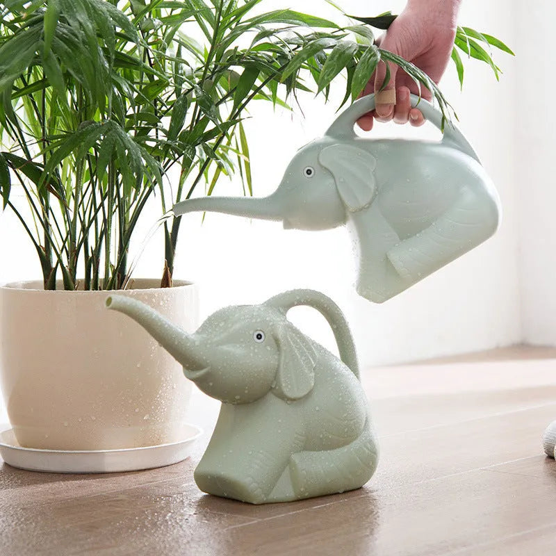 Pink children's elephant-shaped watering can with a long nozzle and baby bottle handle.