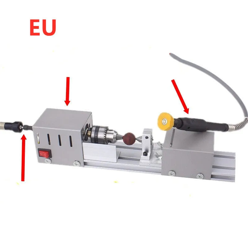Silver metal mini woodworking lathe with carving knives on a workbench