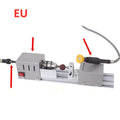 Silver metal mini woodworking lathe with carving knives on a workbench