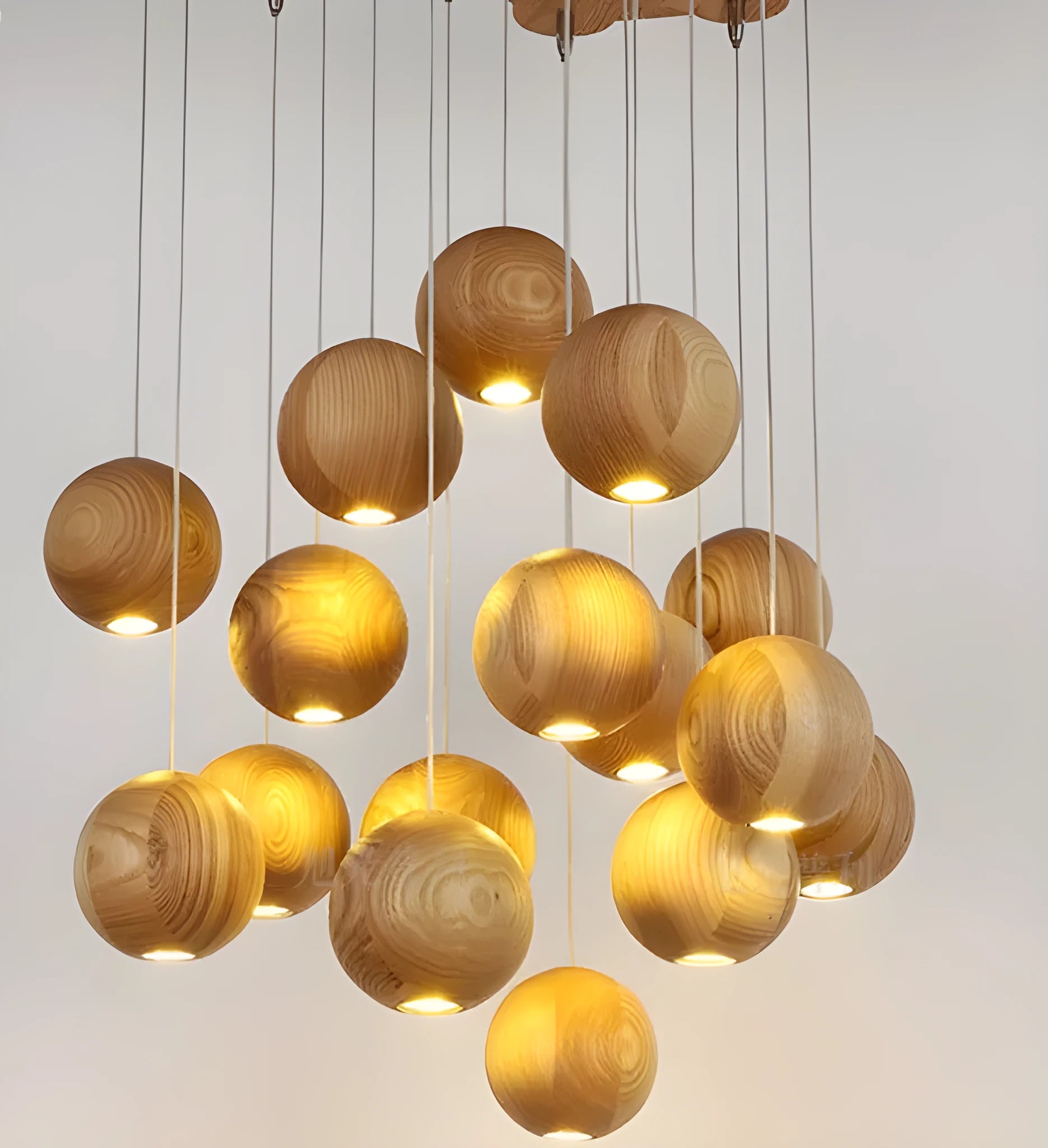 Nordic-style wooden ball chandelier with adjustable cord, shown in single-head and three-head styles on a wood disc base.
