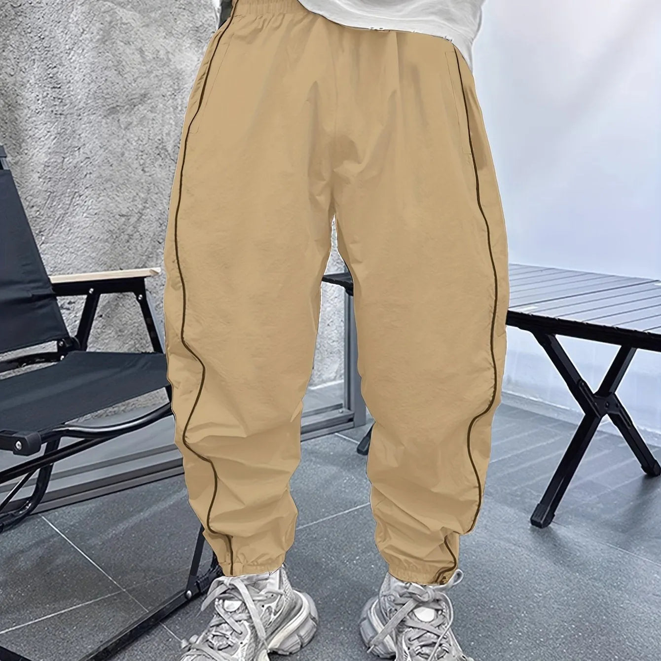 Man wearing blue bamboo fibre casual trousers with a cropped leg and loose fit.