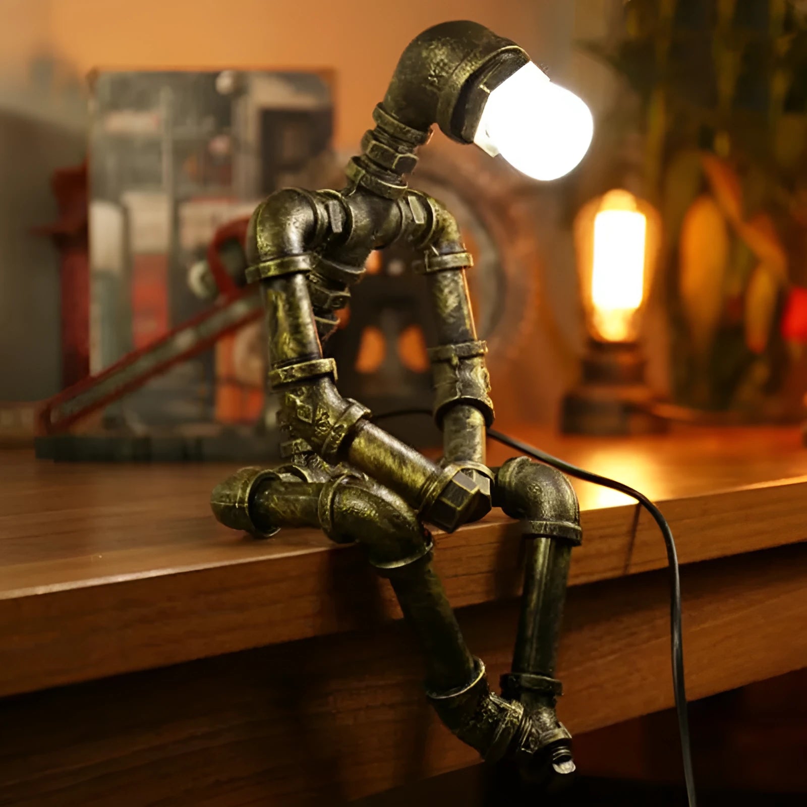 Green bronze vintage industrial robot desk lamp with iron pipe design on a wooden table.