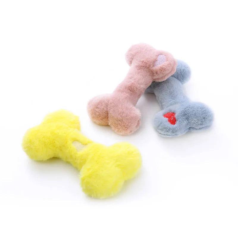 Cute love bone shaped plush dog toy in blue, pink, and yellow colours for interactive chewing play.