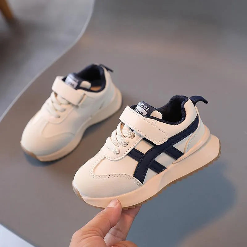 Children's white synthetic leather sneakers with Velcro fastening and a rubber sole