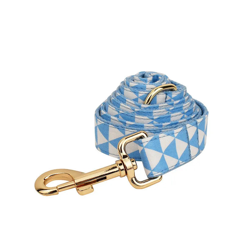 Blue triangular pattern dog harness set with matching leash, collar, and fabric bow accessory