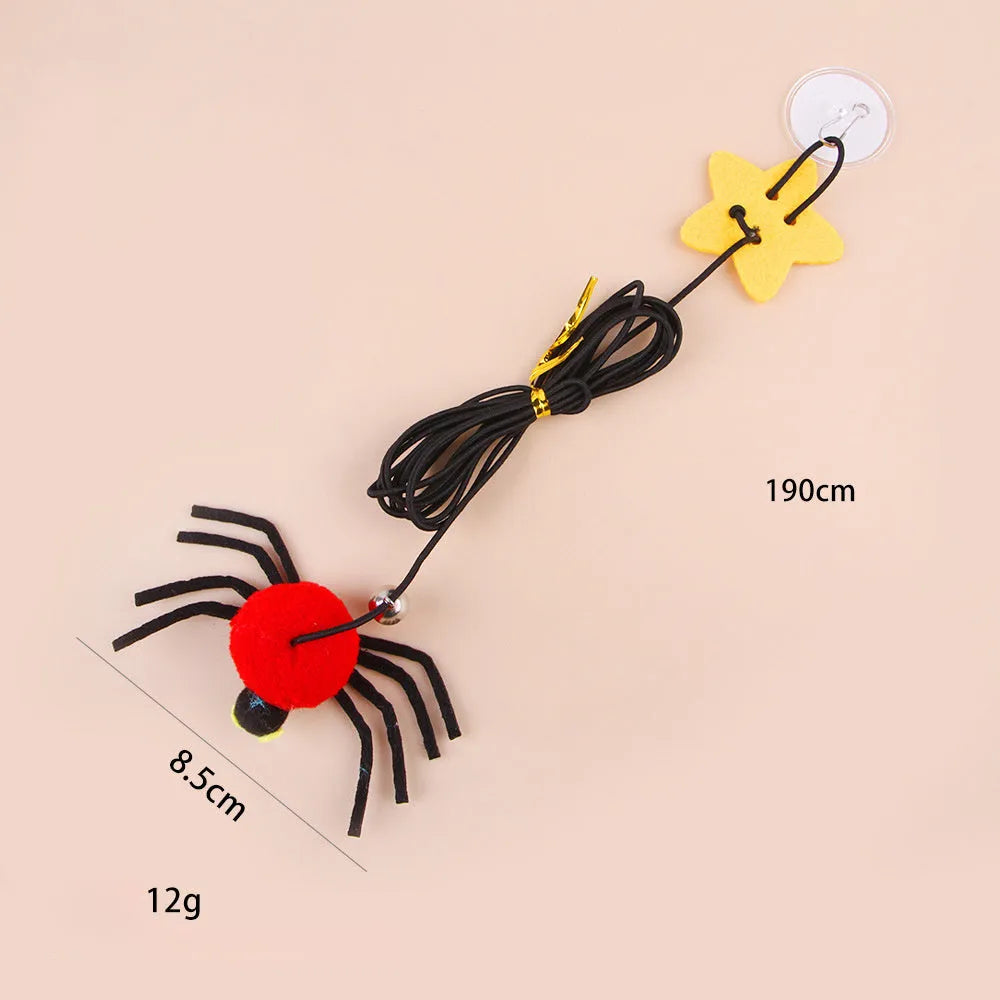Cat door hanging toy with elastic rope, feather, bell, and spider design in red colour