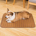 Brown woven rattan cooling mat for dogs on a wooden floor.