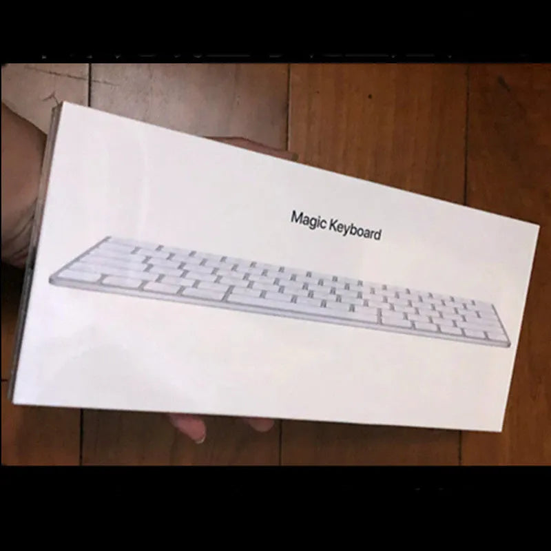 White Apple ultra-thin metal Bluetooth G6 wireless keyboard on a desk.