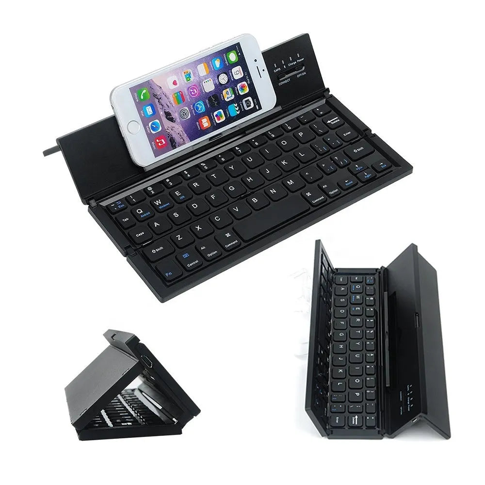 Black folding wireless Bluetooth keyboard unfolded next to tablet showing mini keyboard size