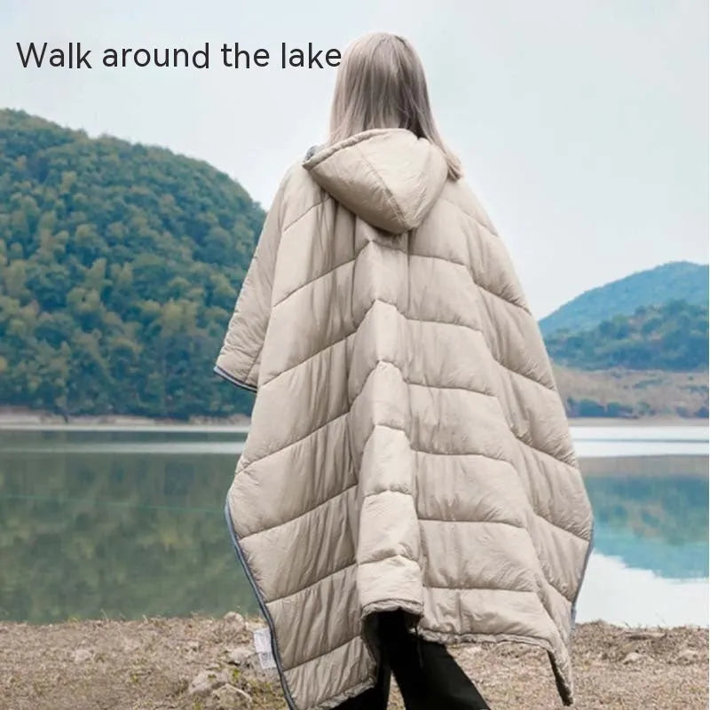 Grey outdoor cloak sleeping bag with hood showing transformation to wearable cape