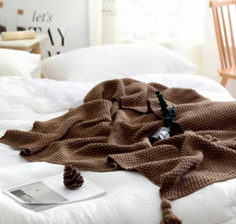 Nordic fringed knit ball acrylic blanket in beige colour, laid flat showing 130x170cm size and fringe detail