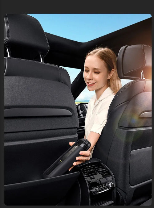 BASEUS black handheld car vacuum cleaner with hose on a car seat.