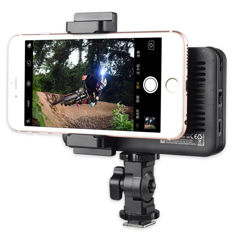 Shenniu M150 ultra-thin silver LED video light mounted on a mobile phone with adjustable brightness.
