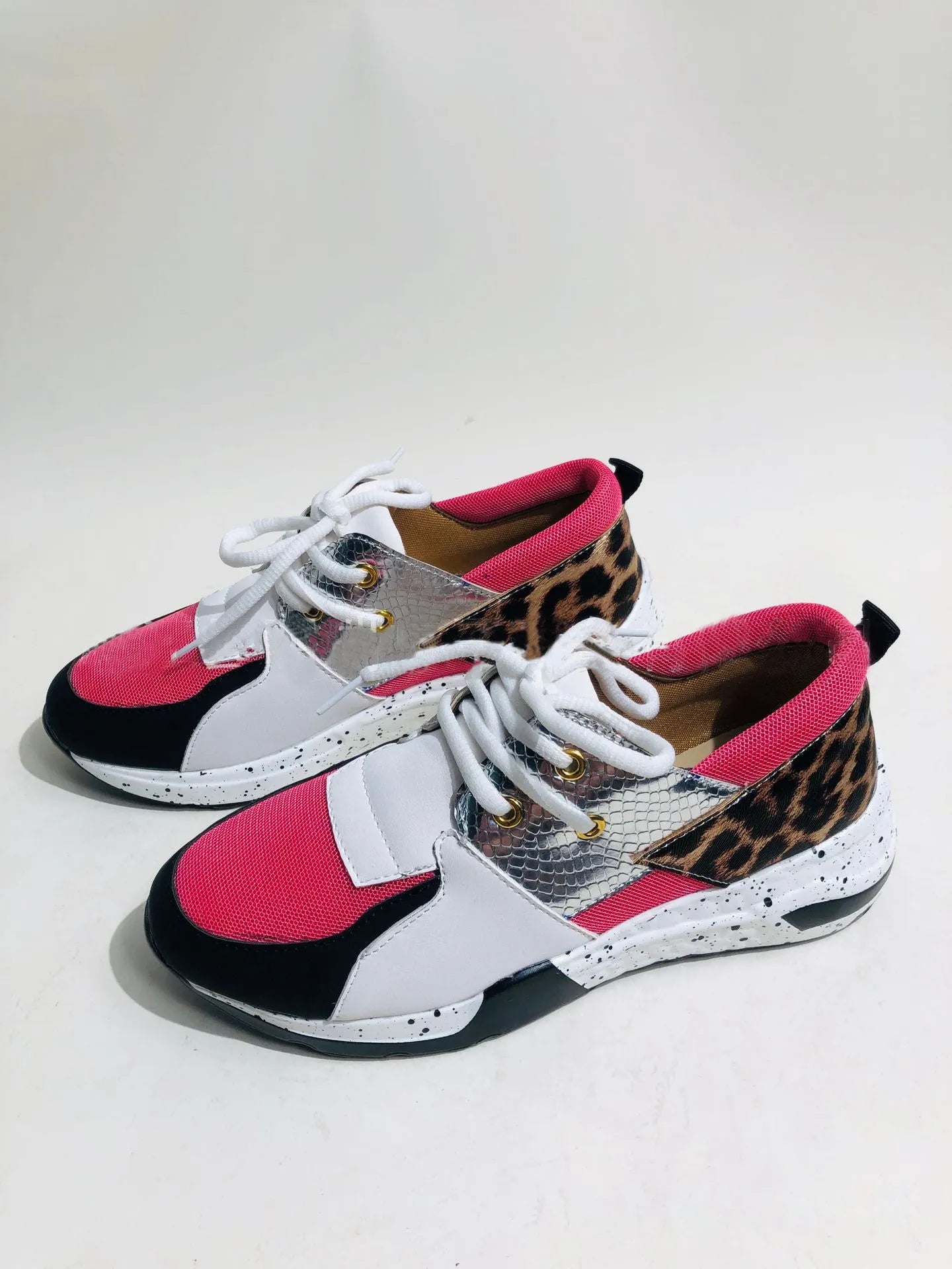 Women's casual suede sneakers with a wedge heel in various colours including black, pink, and leopard print.