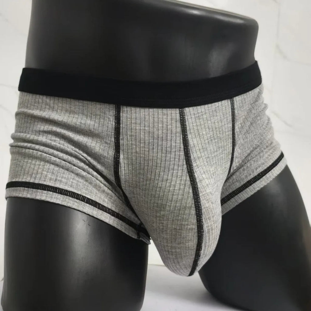 Solid-colour men's boxers in breathable fibre fabric on a size chart.
