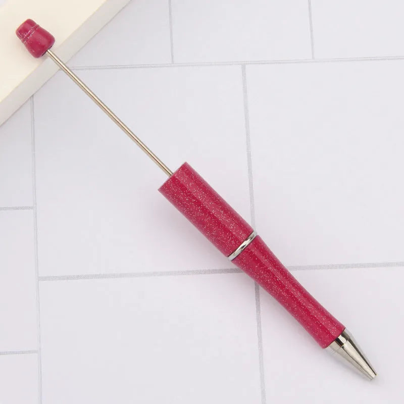 Creative ballpoint pen with multicoloured spinning plastic beads on a steel wire frame.